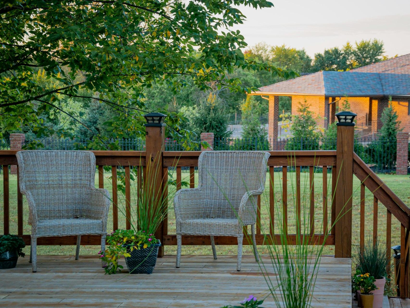 brown wooden fence near green trees during daytime